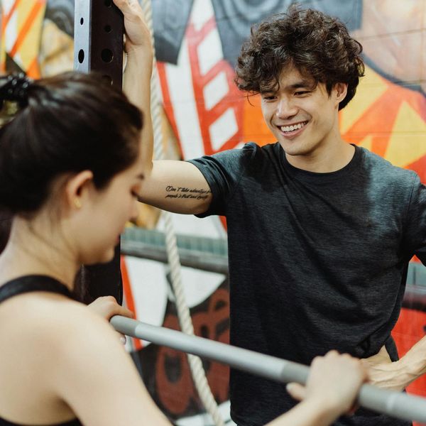 A person smiling and looking refreshed after a workout session at home.